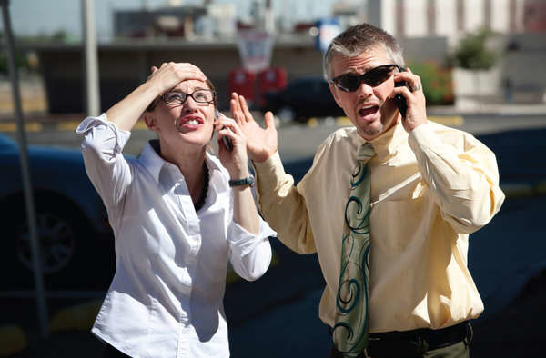 Two people both on cell phones