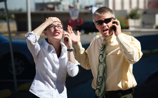 Two people both on cell phones