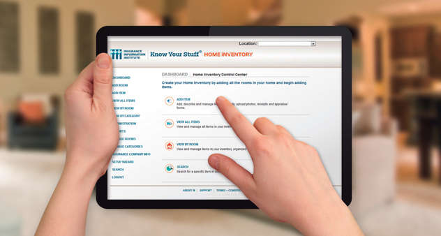 Person holding up tablet with home inventory software displayed