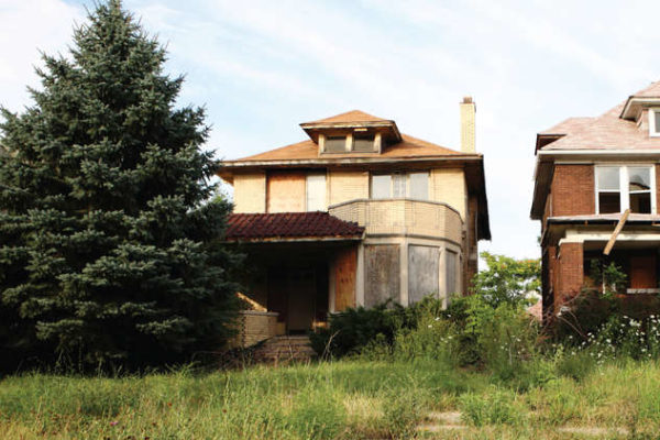 dilapidated house with overgrown yard