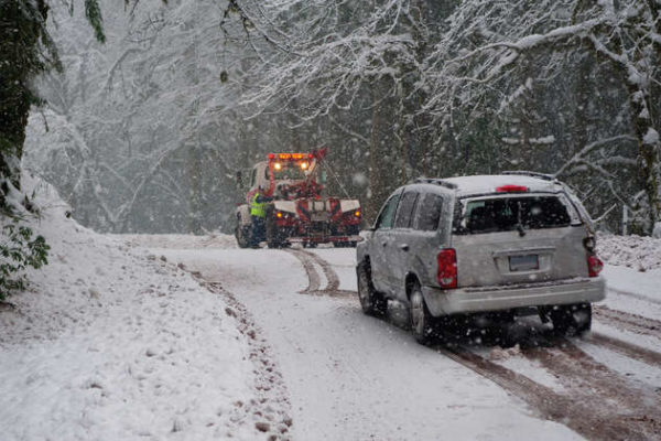 Car getting towed in winter